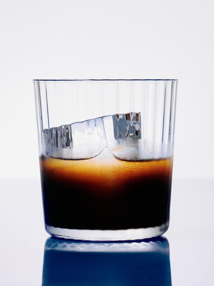GRADA poured over one large ice cube in a rocks glass with a citrus twist