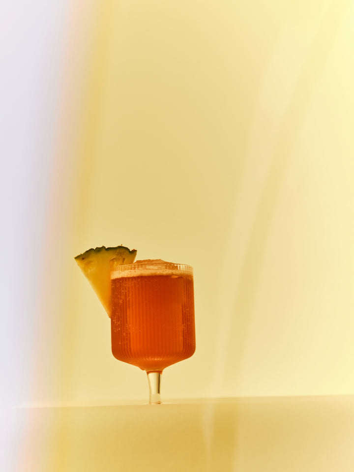 A GRADA Jungle Bird shaken with pineapple juice and served with a pineapple wedge