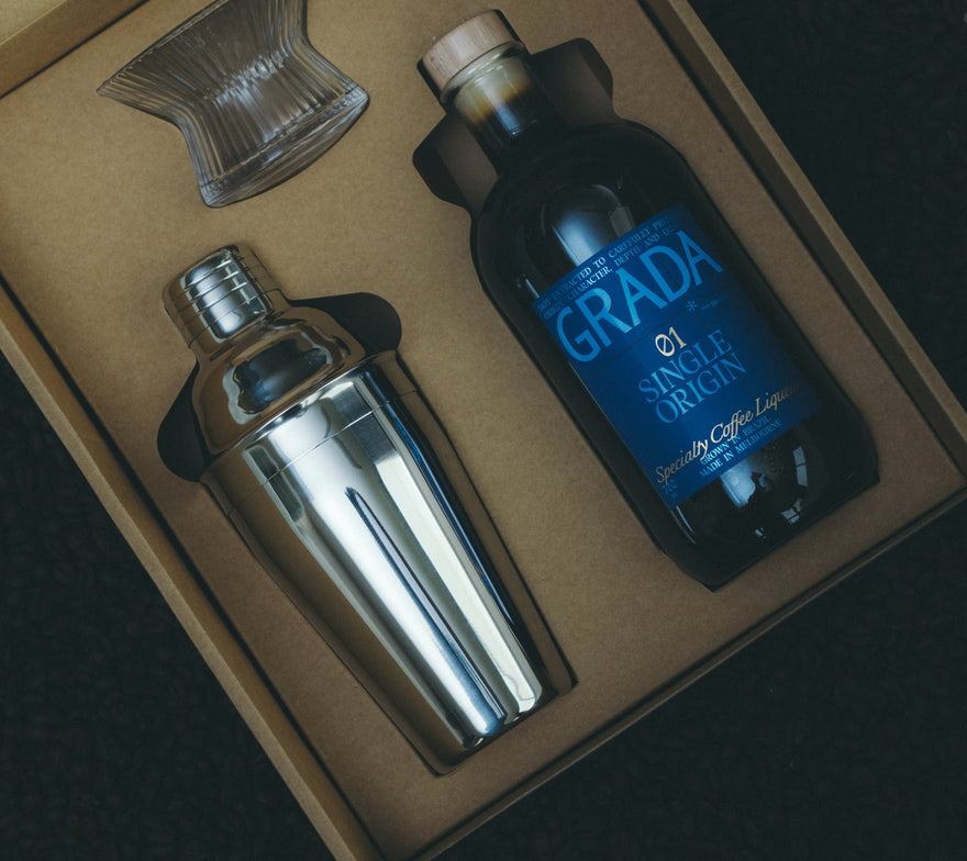 GRADA Gift Box 01 Single Origin — bottle, stainless shaker, hand-blown Japanese coupe and recipe book in branded gift packaging.