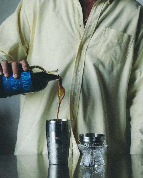 Pouring GRADA into a shaker of ice