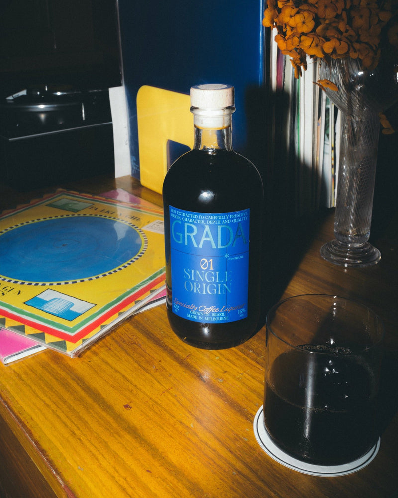 GRADA 01 Single Origin on a timber table next to a glass over ice