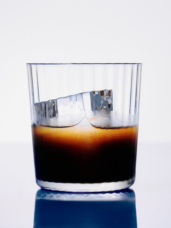 GRADA poured over a large ice cube in a rocks glass