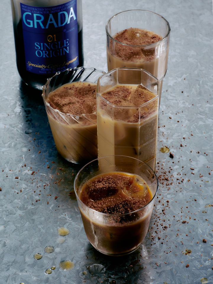 GRADA topped with cold milk over ice, dusted with chocolate