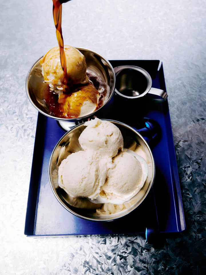 GRADA poured over scoops of vanilla ice cream in a steel bowl